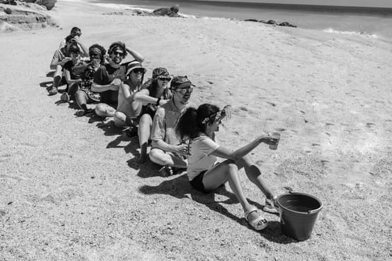 An image of several Chainguard employees playing a game in the sand.